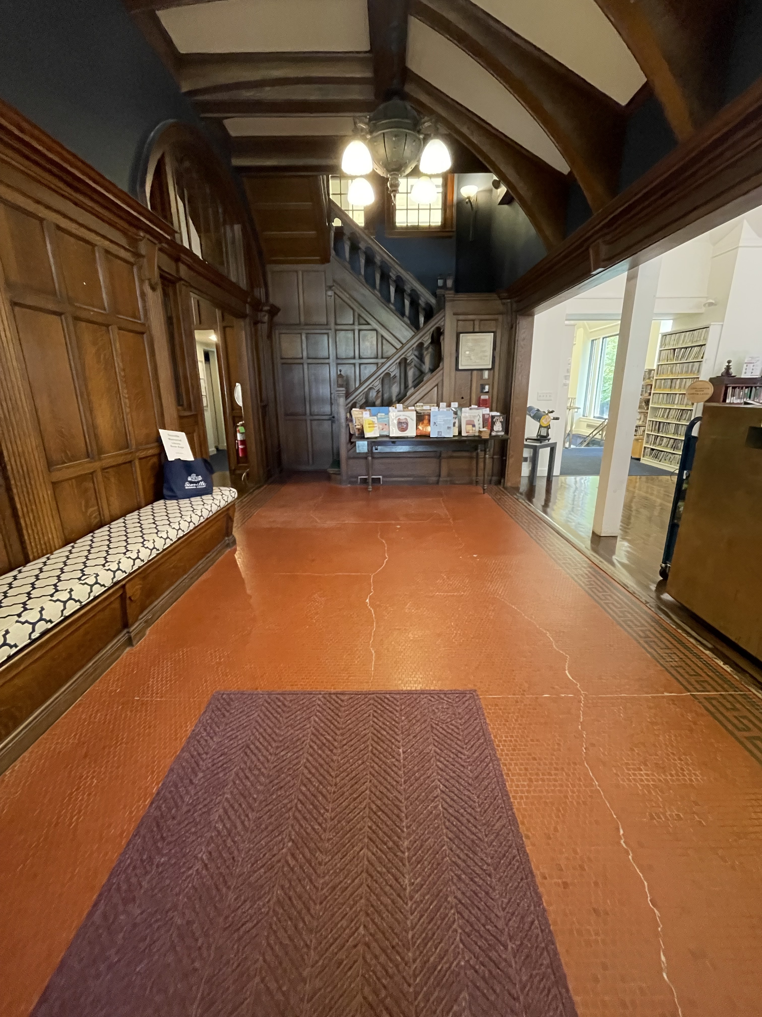  Entryway with orange marble floor, antique staircase and paneled walls