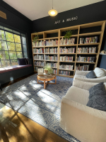 Art & Music room with seating area, blue carpet, and book shelves