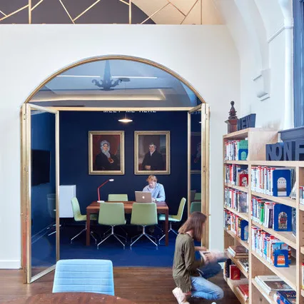 A small work/study room with a rectangular table and six chairs.