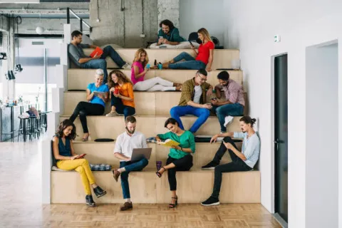 group of young people reading and sitting on giant steps