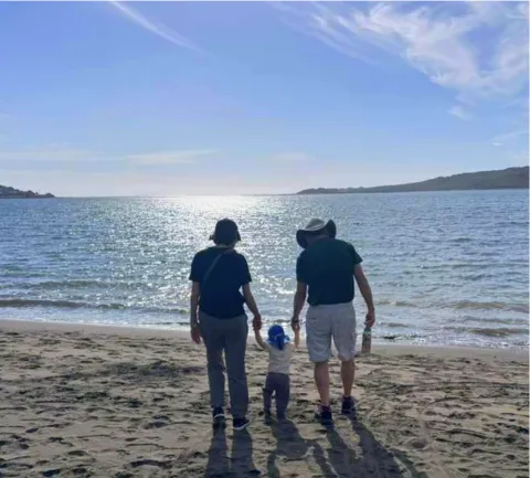 people on a beach watching the sun rise