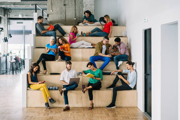 group of young people reading and sitting on giant steps