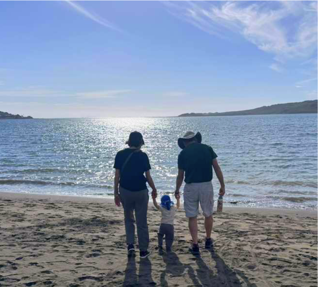 people on a beach watching the sun rise